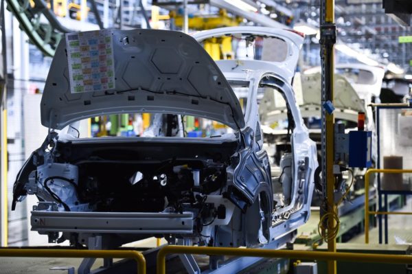 blue car body on a production line or assembly line in a manufacturing plant